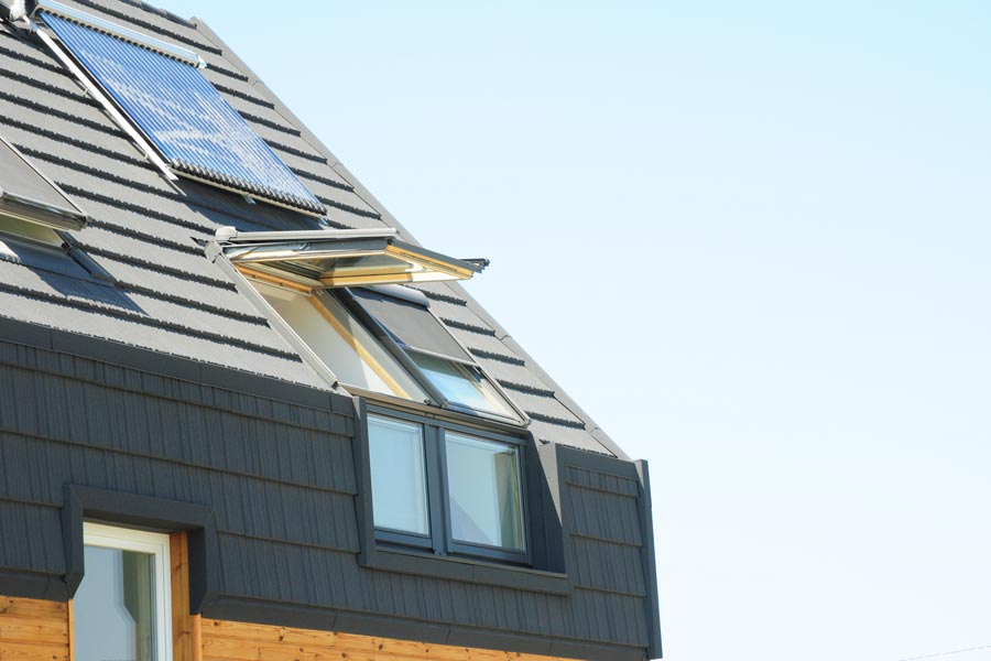 Photo of the roof of a home with the windows open.