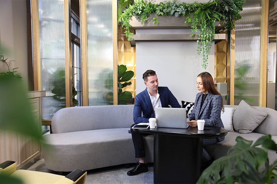 business people using a laptop while working in green eco friendly modern working space