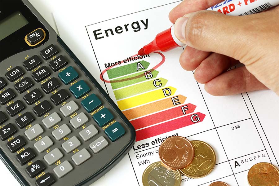 A photo of a piece of paper with the words "Efficient Energy" circled. There is also a calculator and coins in the frame.