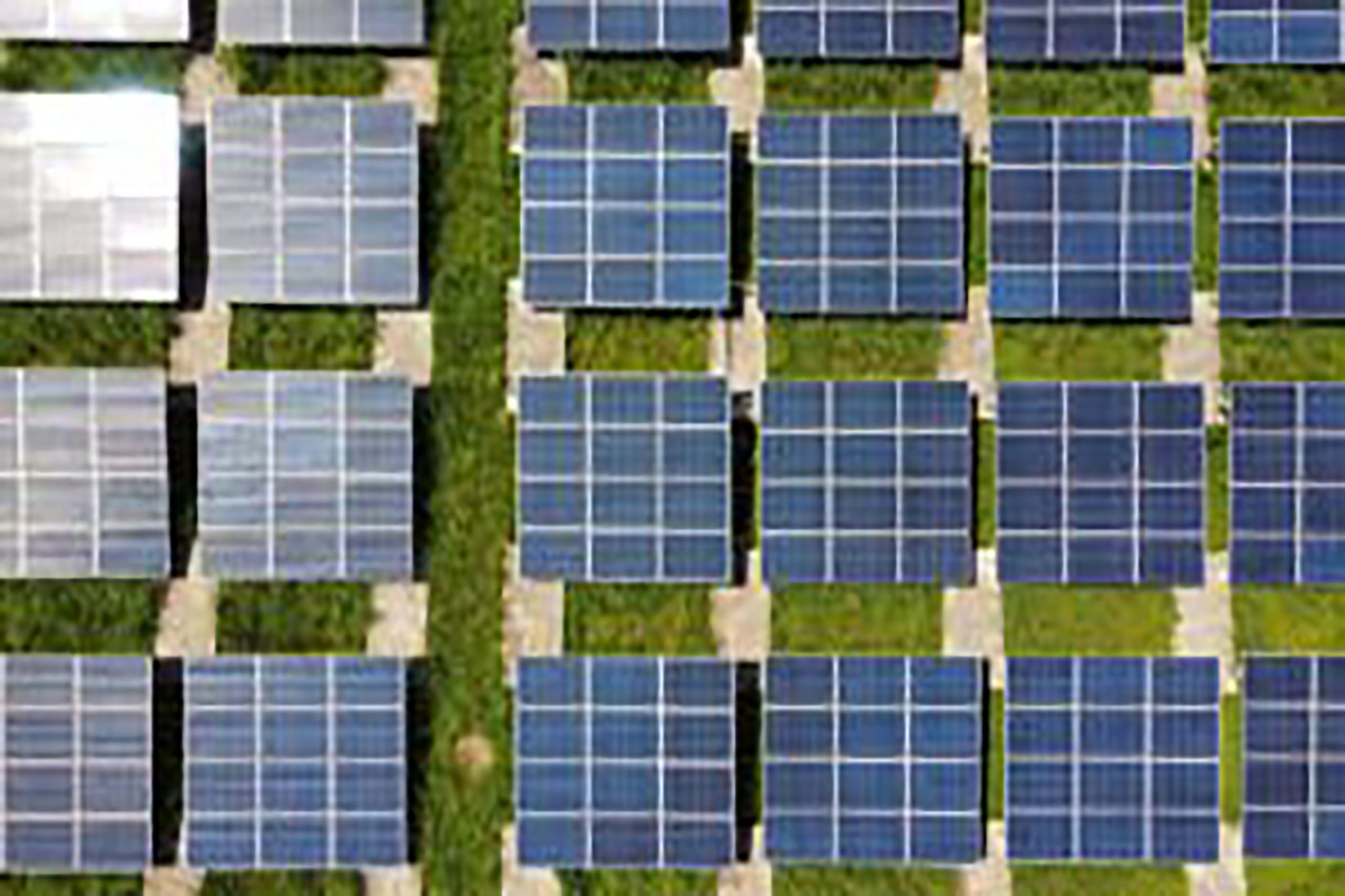A photo from above of 24 square solar panels.