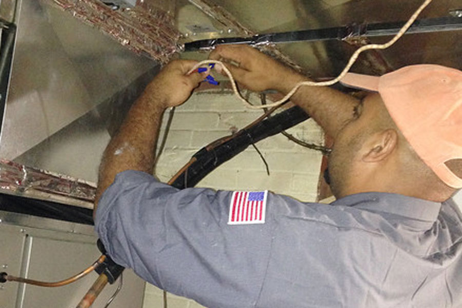 Contractor works to fix wiring in a basement