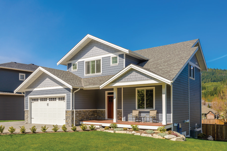 a newly built home with gray, white and stone exterior