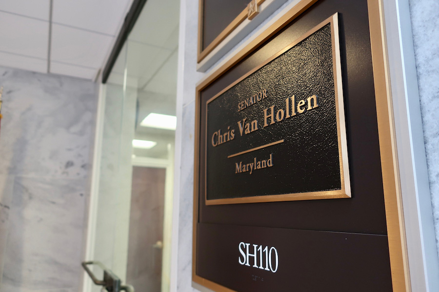 Photo of a sign on a wall reading, "Senator Chris Van Hollen"