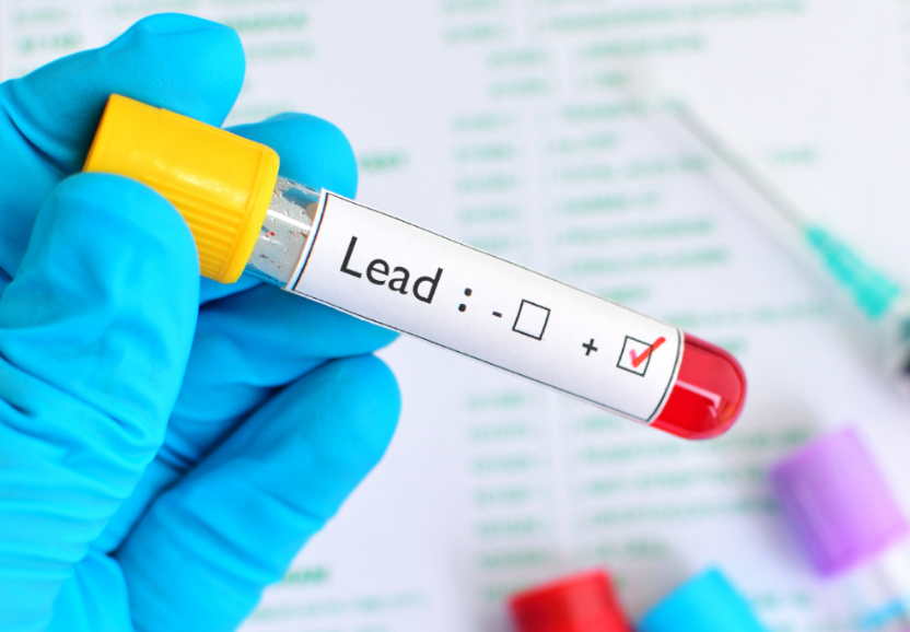 A photo of a sample tube that reads "Lead" with red liquid inside.