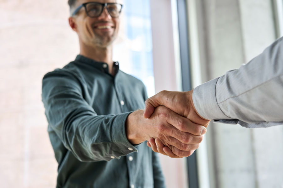 Two men shaking hands in agreement to be a part of BPA.