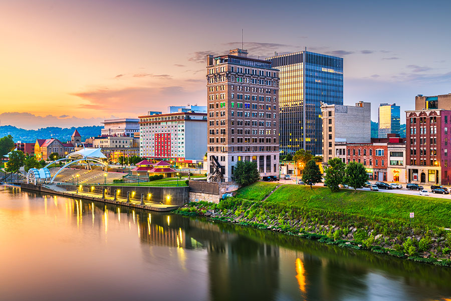 Charleston, West Virginia, USA downtown skyline on the river at dusk.