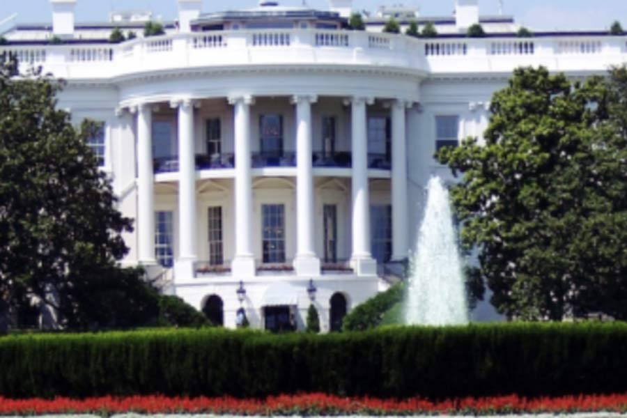 Close-up photo of the White House in Washington D.C. The fountain is moving water in the front.