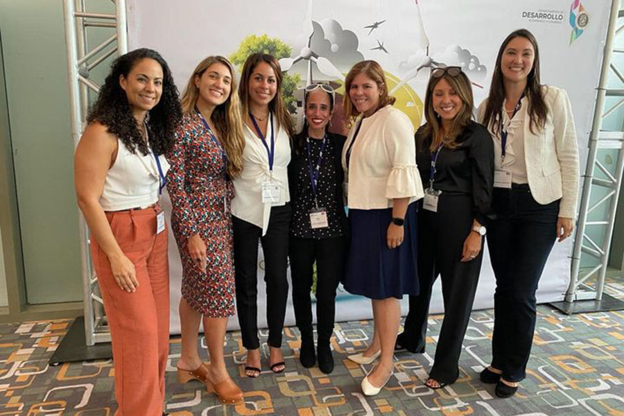 Maria Lewis and a group of six others are smiling for a photo at the Puerto Rico Energy Week 2023.