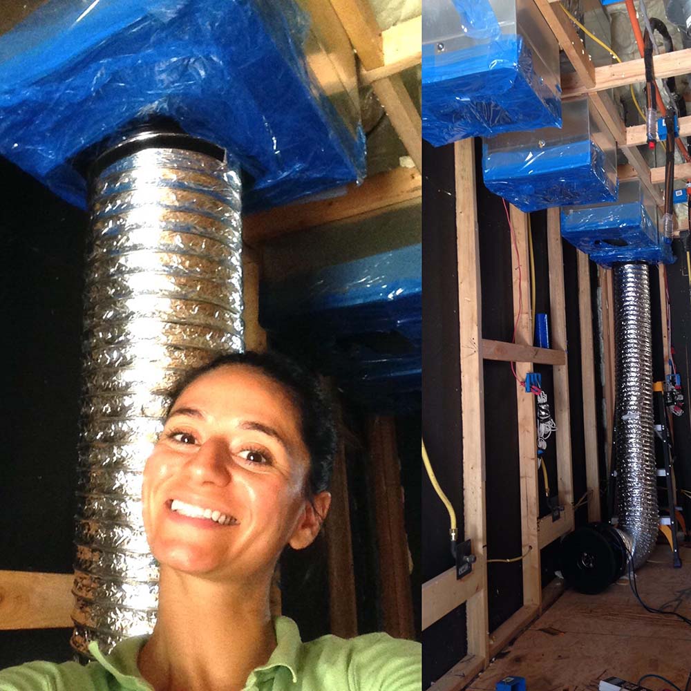 Selfie of Elena Chrimat next to duct work