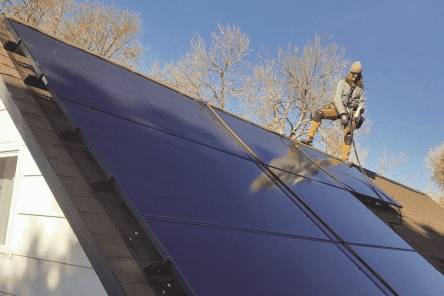 Woman working on a solar panel.