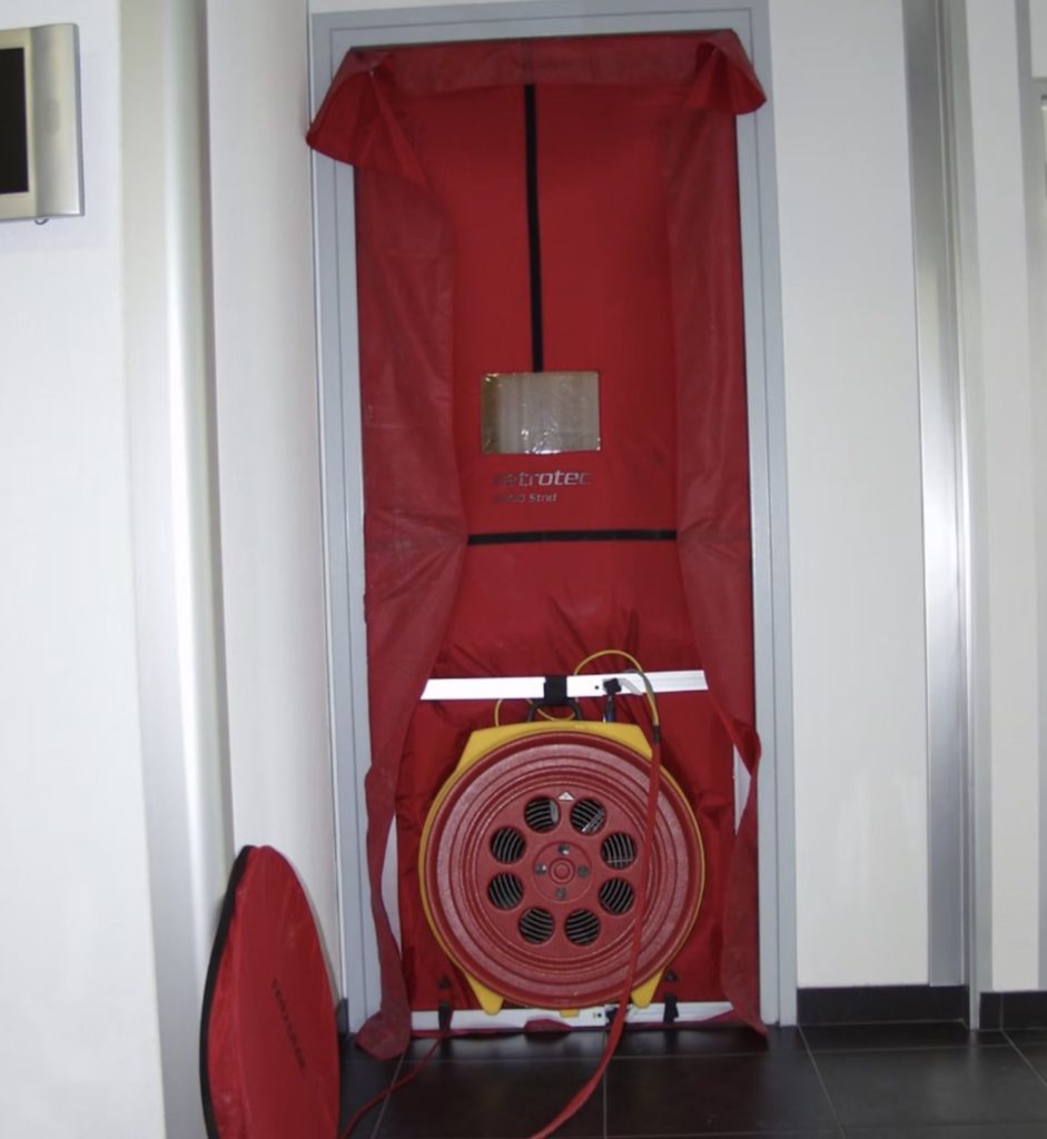 Blower door installed in doorway for a test