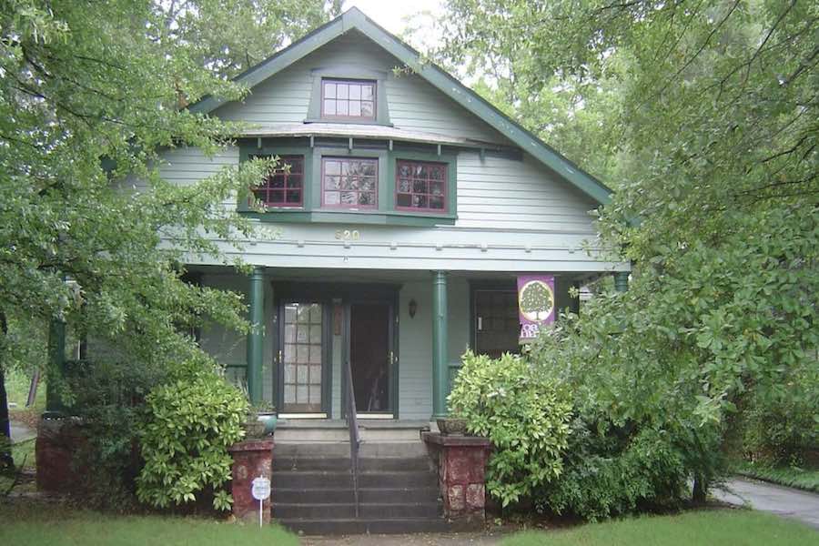 Older home surrounded by trees