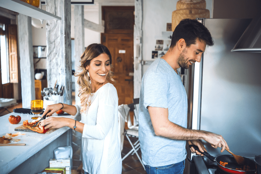 man and woman cooking in kitchen