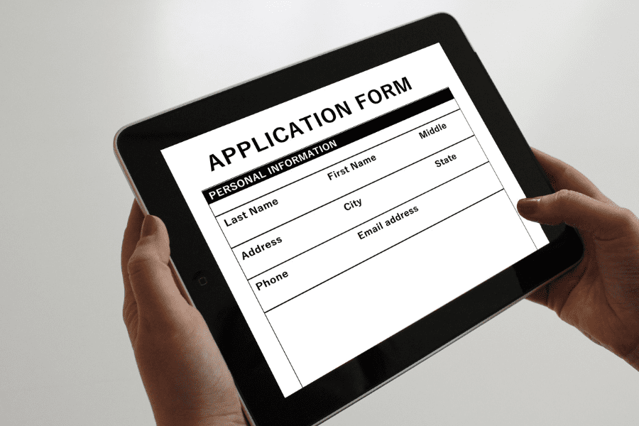 Hands holding tablet with Application Form