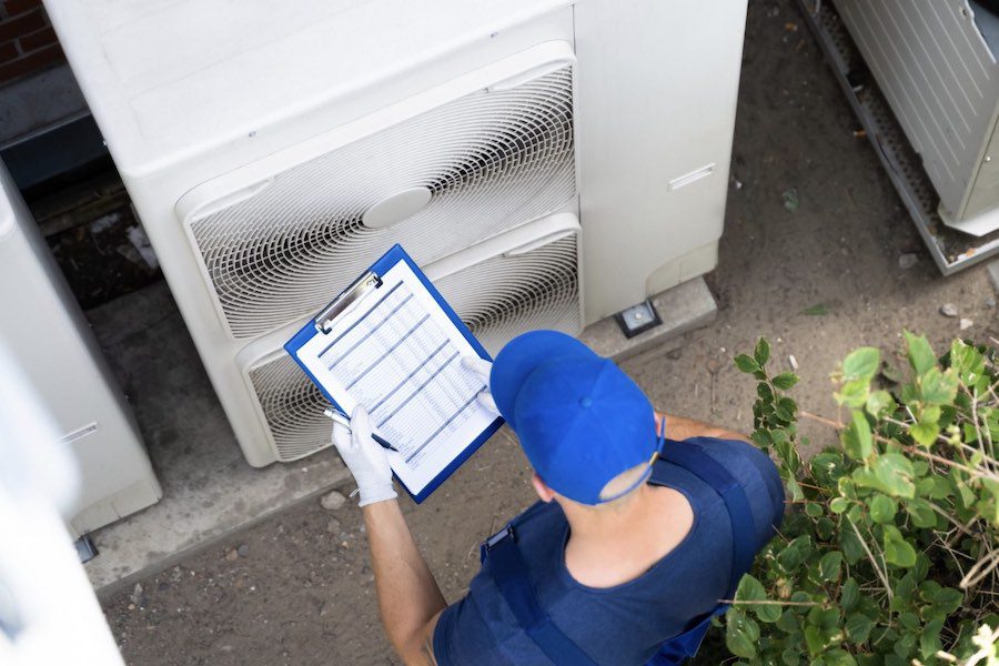 Contractor checks his list to make sure all energy upgrades are complete.