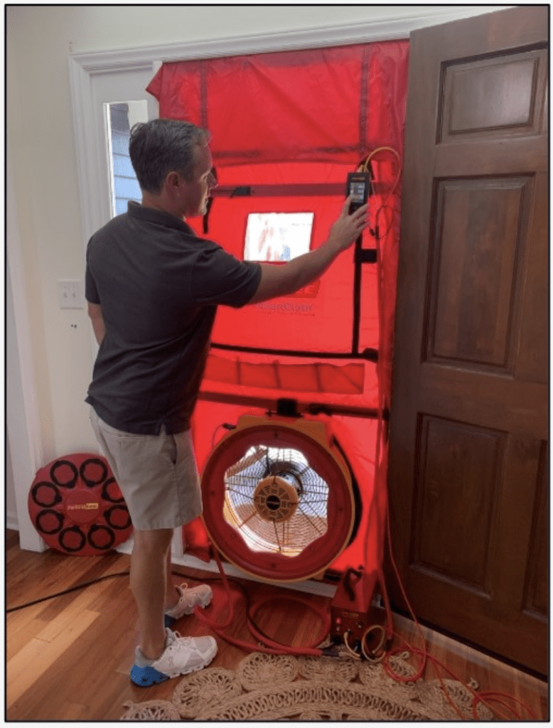 Man using a blower door test.