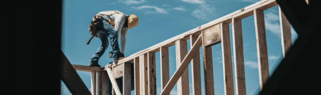 Contractor working on frame of building