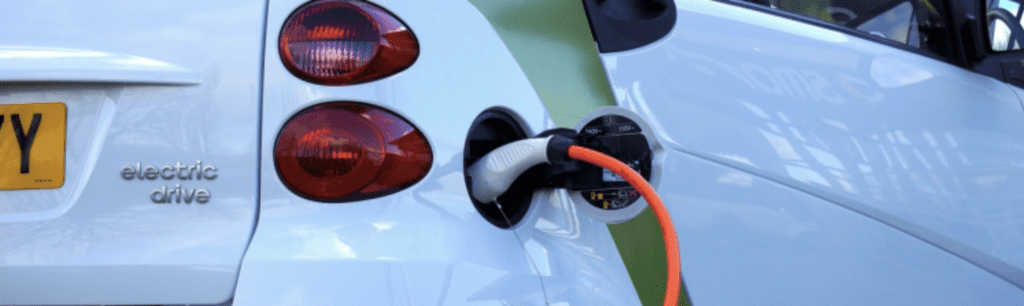 Electric vehicle hooked up to charger