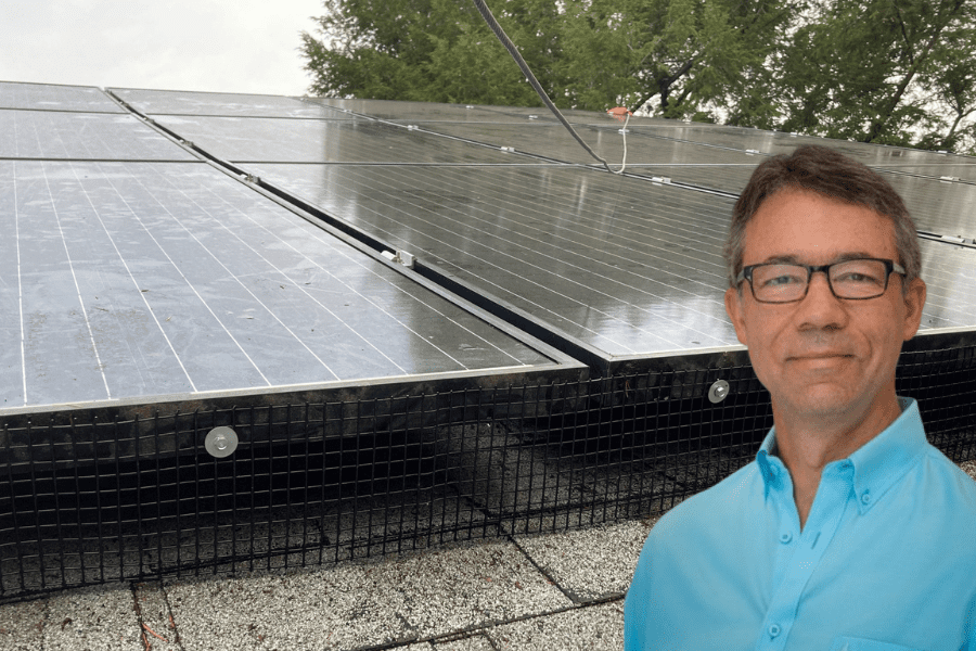 Scott Willenbrock in front of solar panel array