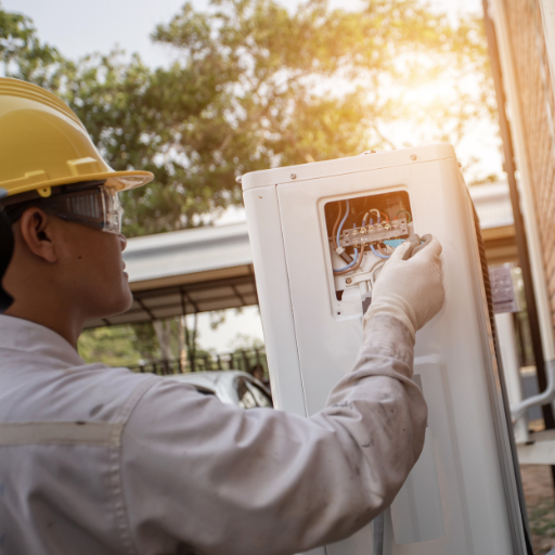 Technician installing energy-efficient heat pump in a residential building.