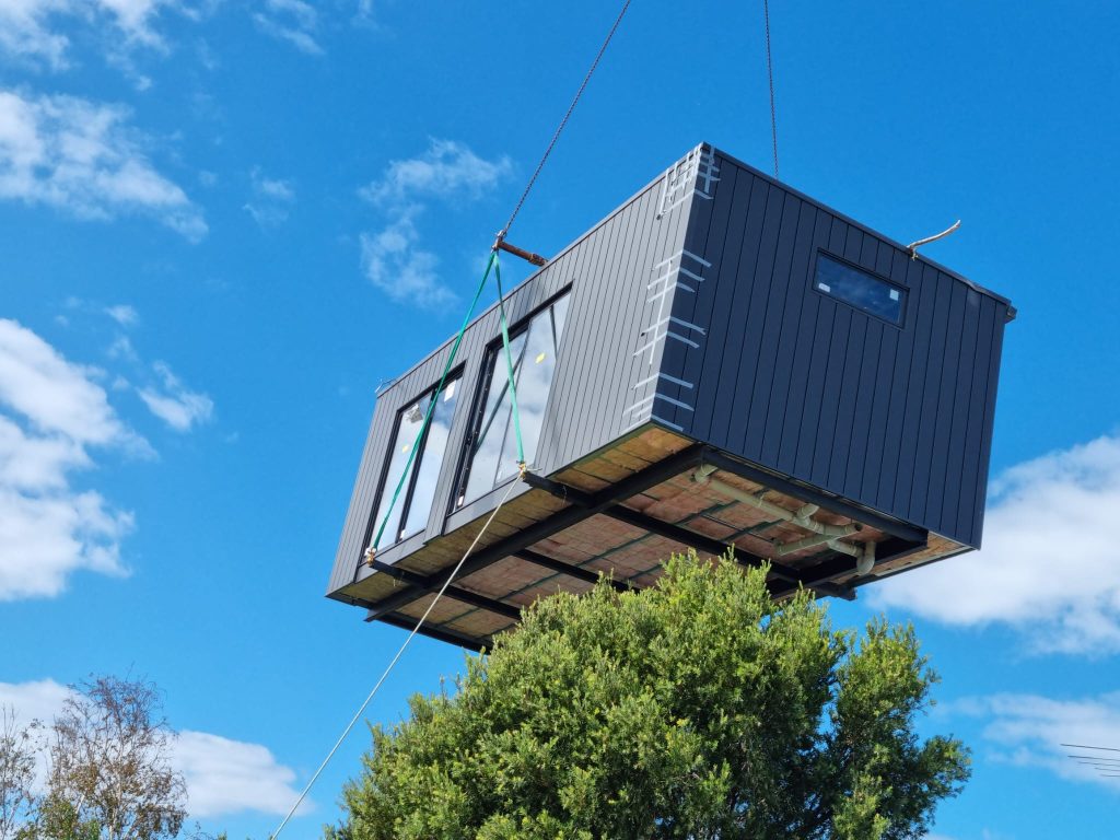 Prefabricated Home Office being lifted onto a foundation.