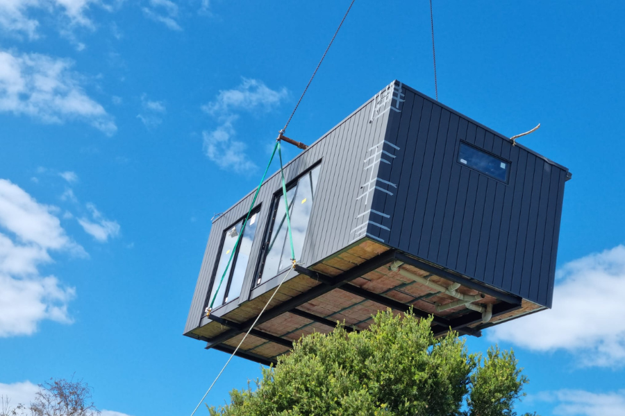 Modular home office being lifted onto foundation