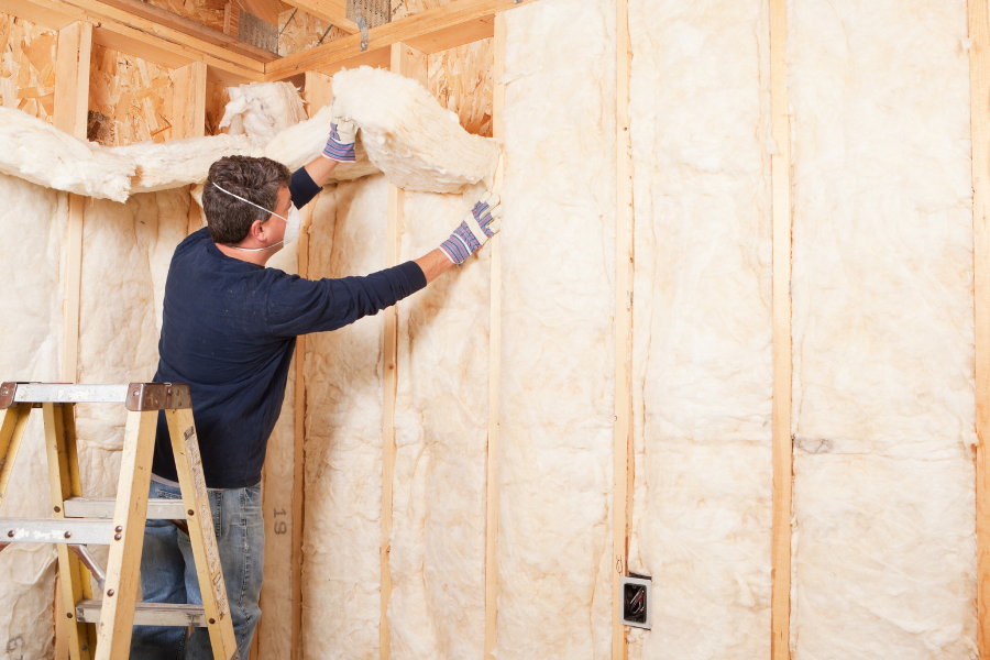 man installing insulation