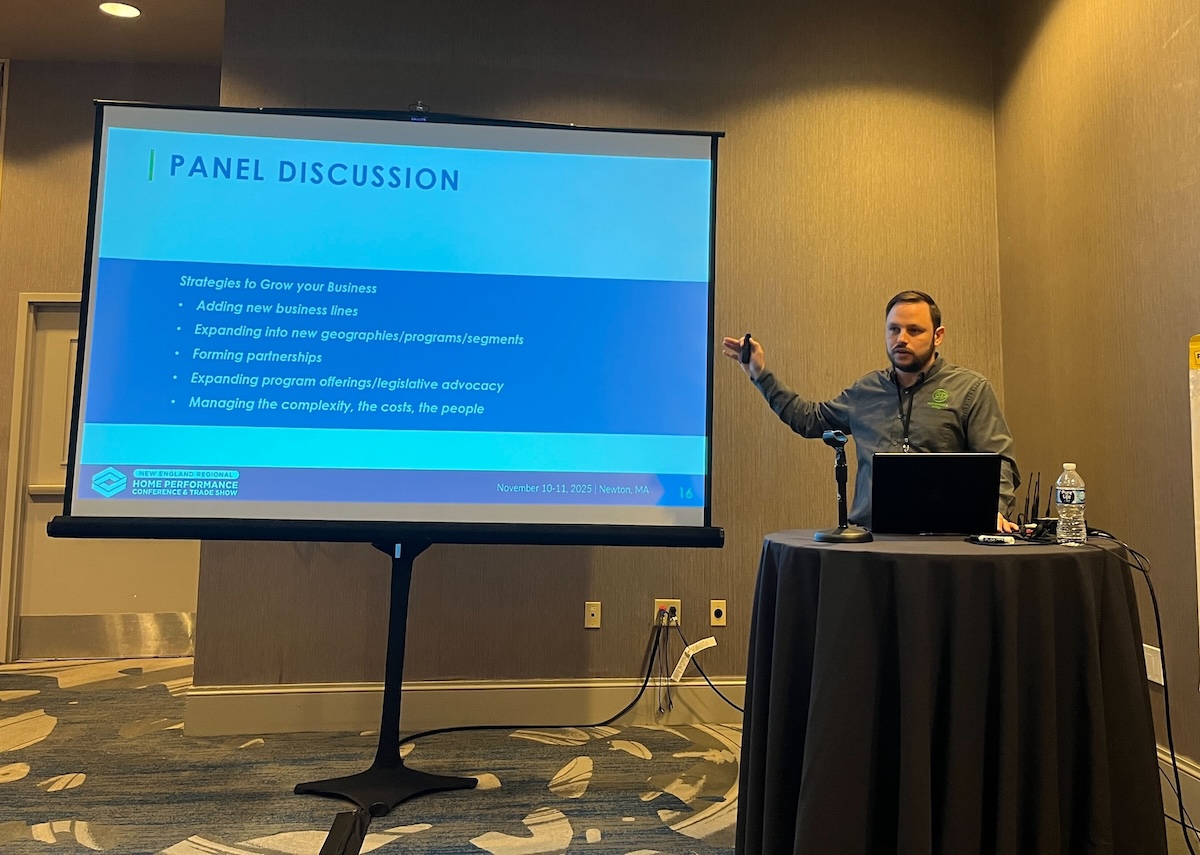 Presenter pointing to a slide show, taken at BPA's 2025 New England Regional Home Performance Conference and Trade Show