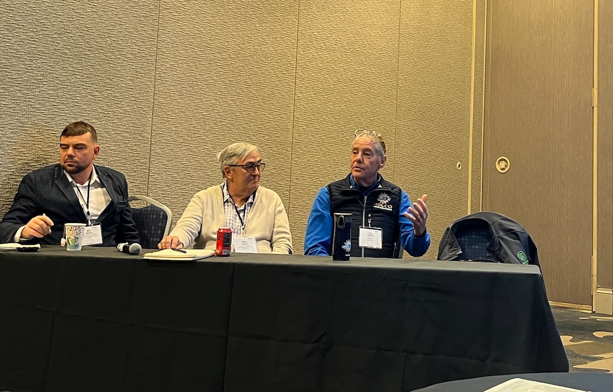 Panel of three presenters seated at a table, taken at BPA's 2025 New England Regional Home Performance Conference and Trade Show
