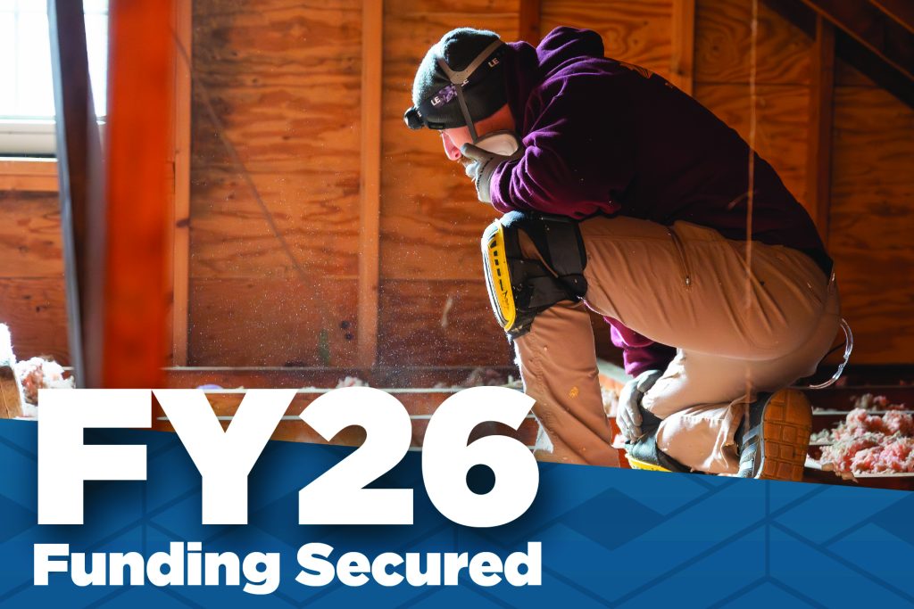 Image of contractor kneeling in an attic with the text "FY26 Funding Secured."