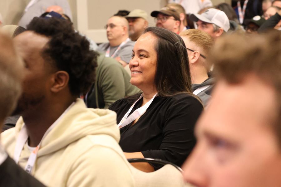 woman sitting at conference, smiling