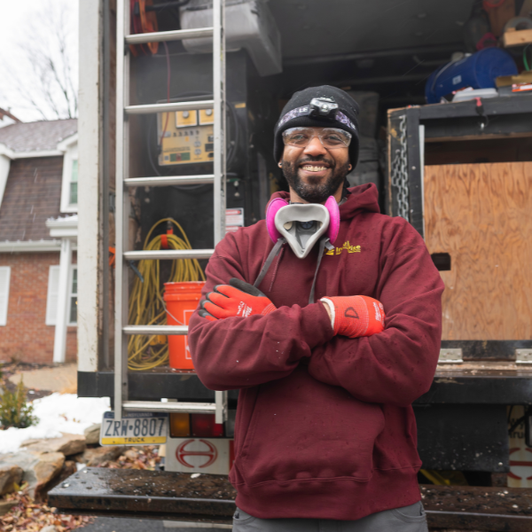 Man standing in front of work truck smiling